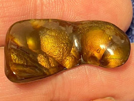 Deer Creek Fire Agate Gemstone held between fingers