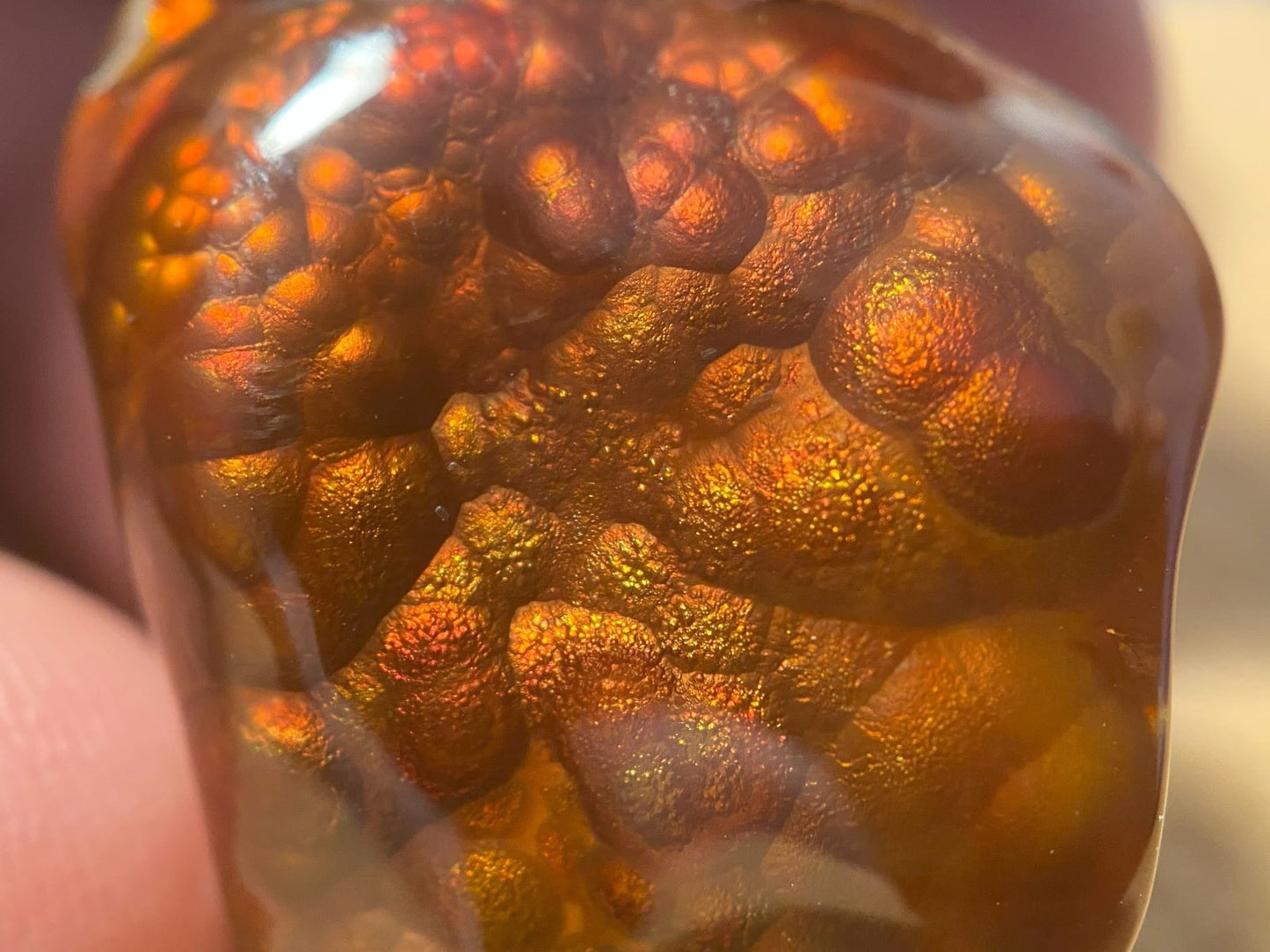 Close-up of a polished Slaughter Mountain fire agate gemstone stone with intricate fire patterns