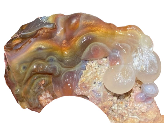 Colorful Slaughter Mountain fire agate rough with intricate patterns on a white background