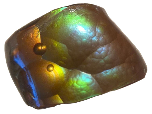 Iridescent Deer Creek Arizona fire agate gemstone with vivid multicolored surface on a neutral background