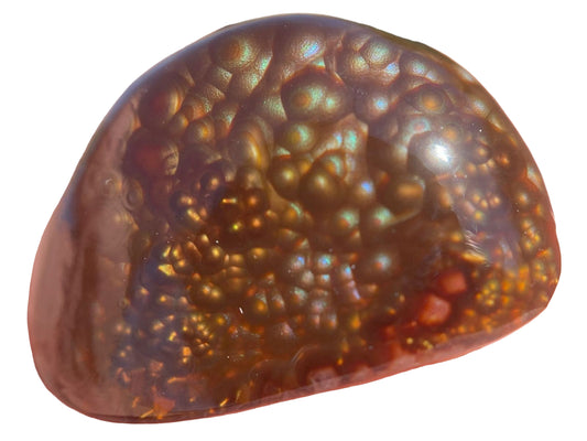 Close-up of a Deer Creek Fire Agate Gemstone with a textured surface on white background.