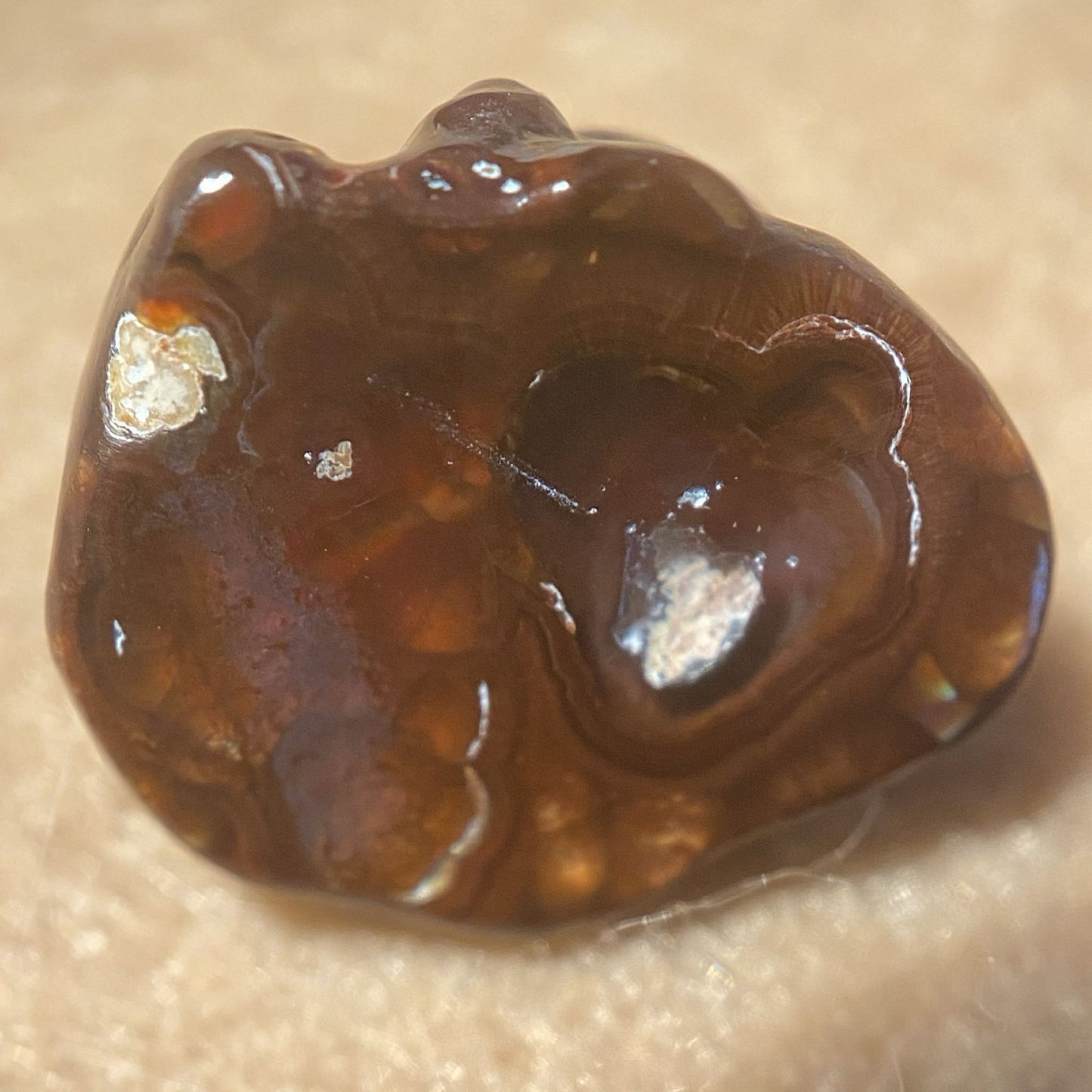 Bottom of colorful Deer Creek Mineral Specimen on a beige background