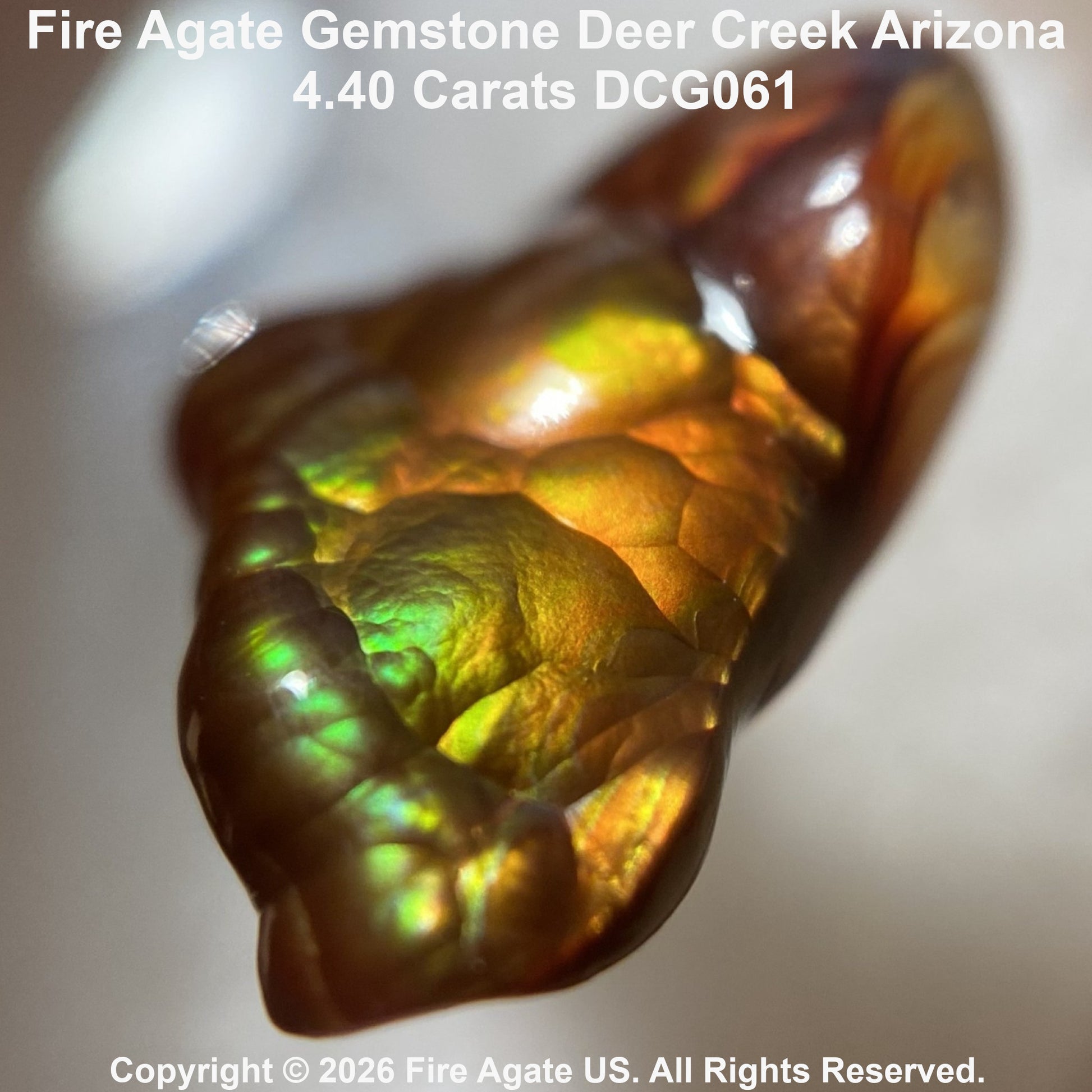 A 4.40 carat Fire Agate gemstone from Deer Creek Arizona, featuring a textured, organic shape with a shimmering iridescent color palette of gold, green, and copper-brown.