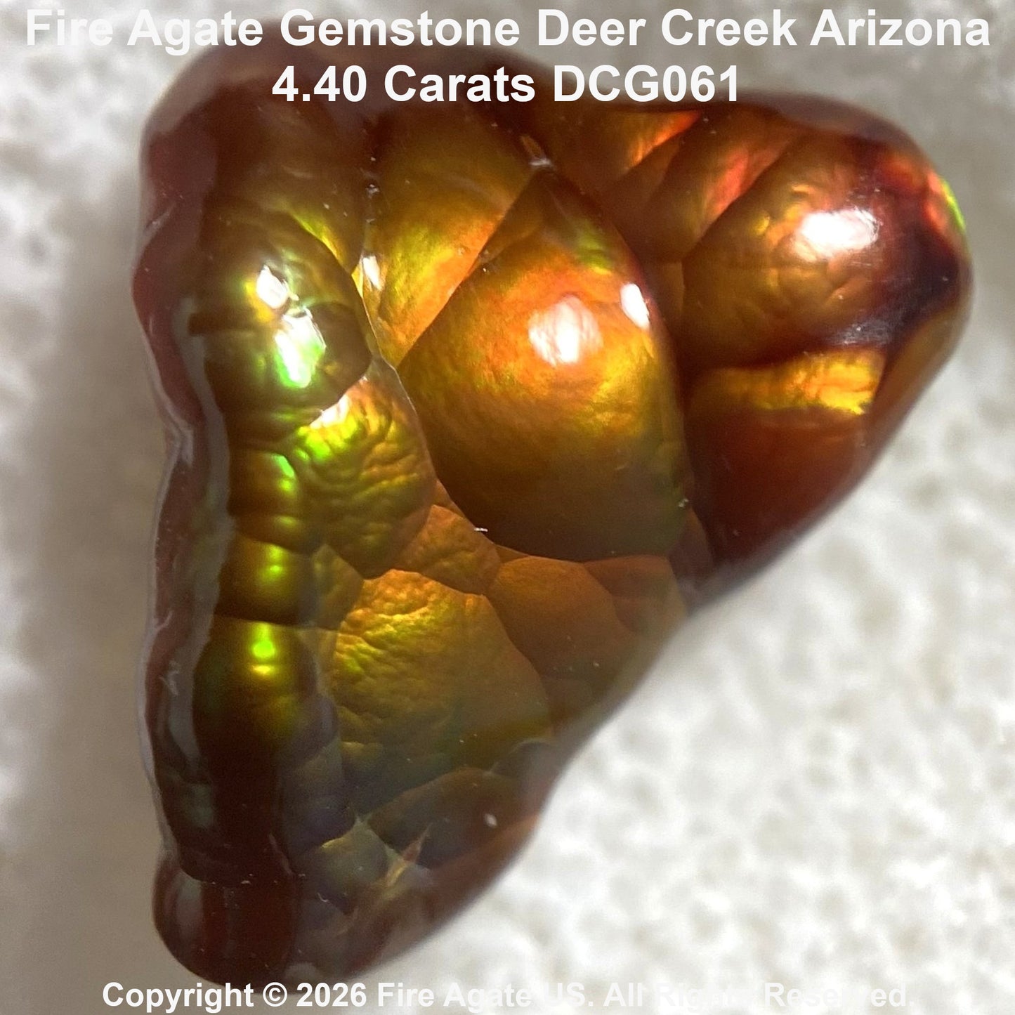 A 4.40 carat Fire Agate gemstone from Deer Creek Arizona, featuring a textured, bubbled surface with a shimmering color-shifting play-of-color between gold, green, orange, and deep brown.