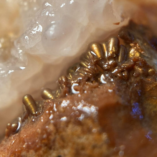 Close-up of sagenite crystal formation on a piece of Deer Creek fire agate rough