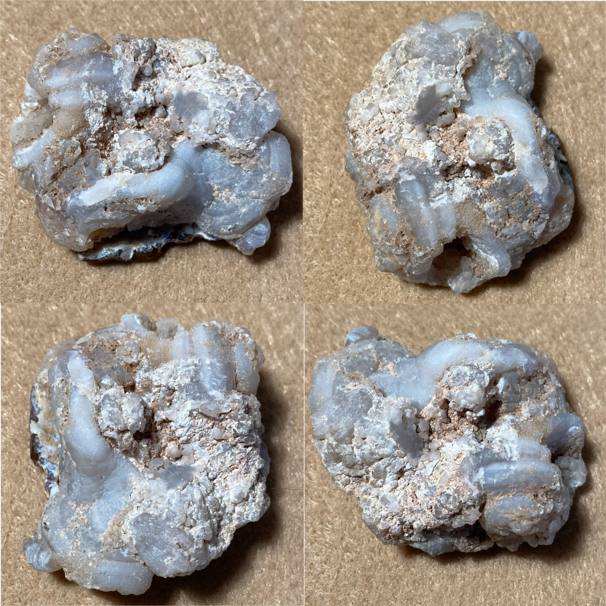 Four fire agate crystal formations on a beige background