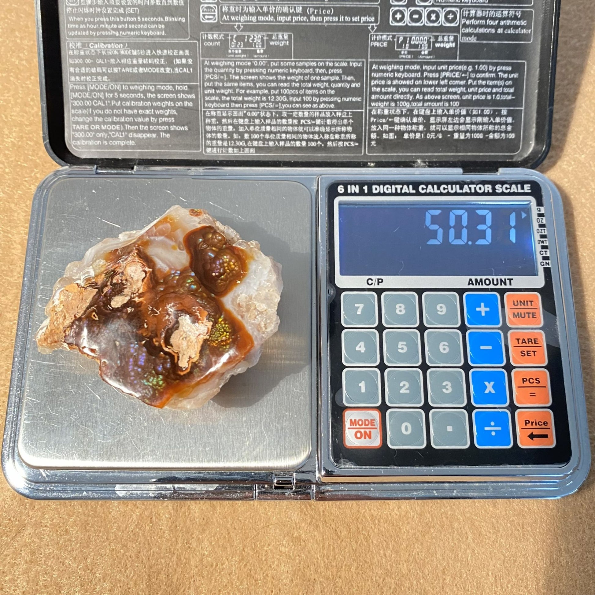 Mineral sample on a digital calculator scale with a displayed weight
