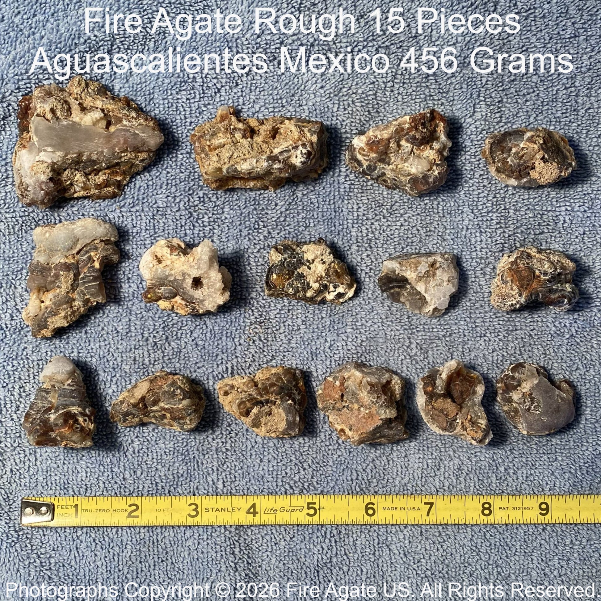 Fire Agate Rough pieces from Aguascalientes, Mexico on a gray background with a Stanley ruler.