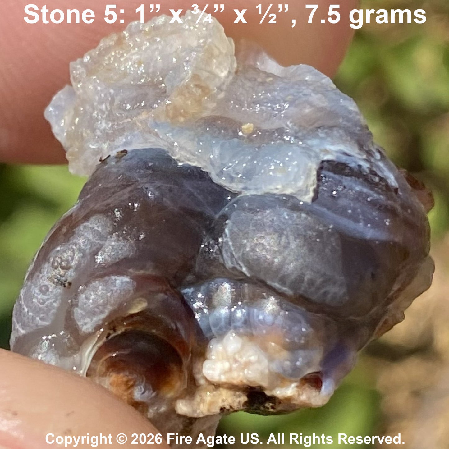 A close-up of a hand holding a rough translucent stone specimen labeled 'Stone 5: 1" x 3/4" x ½", 7.5 grams'