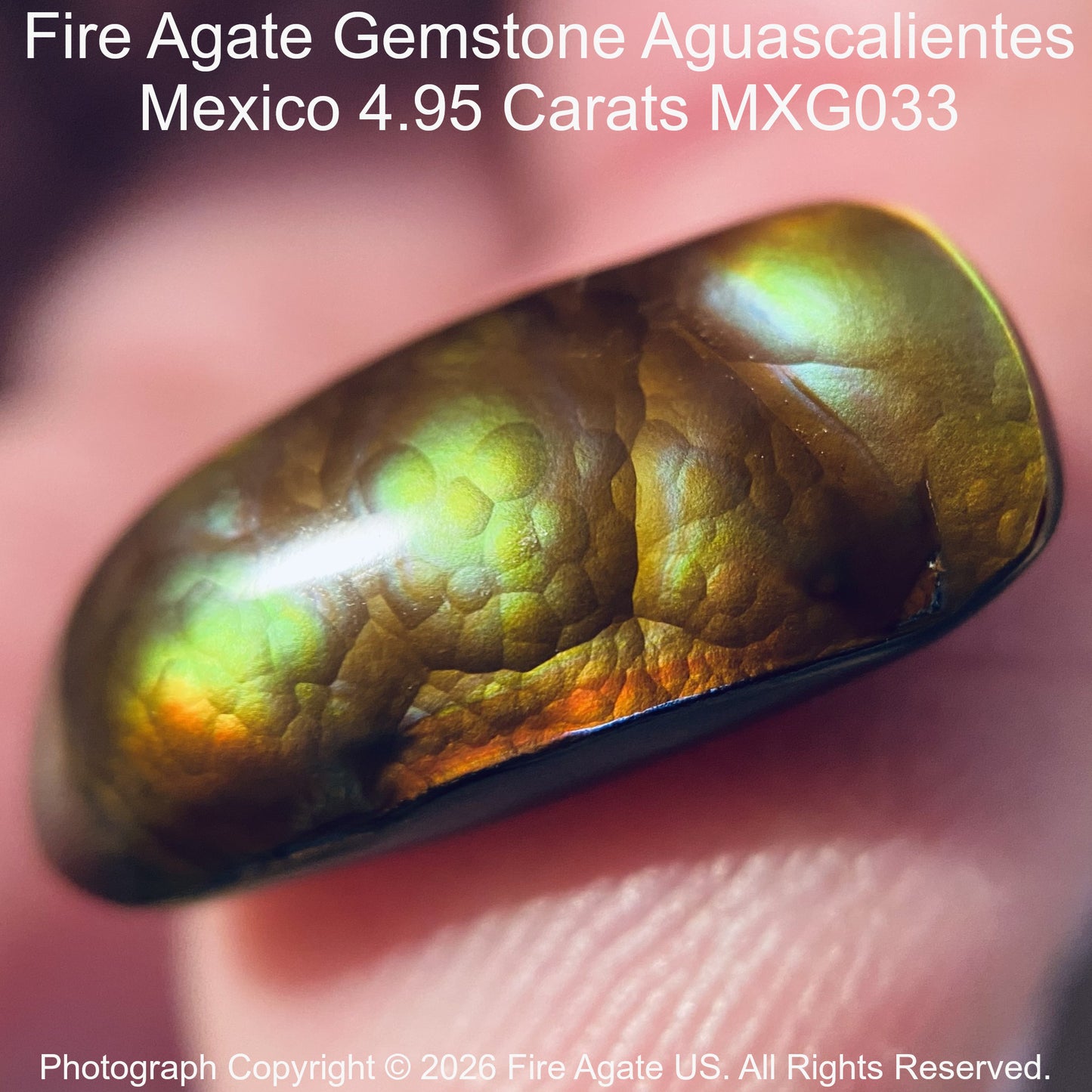 A close-up of a polished Fire Agate gemstone held against a finger, showing its iridescent color-shifting surface with green, gold, and orange tones. Text at the top reads 'Fire Agate Gemstone Aguascalientes Mexico'.