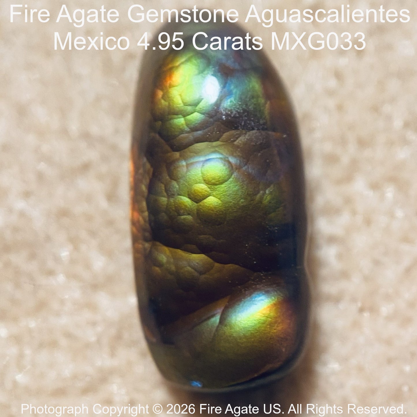 A 4.95 carat Fire Agate gemstone with a dark brown base and vibrant green, yellow, and blue iridescent flashes, shown on a textured beige background with product details text overlay.