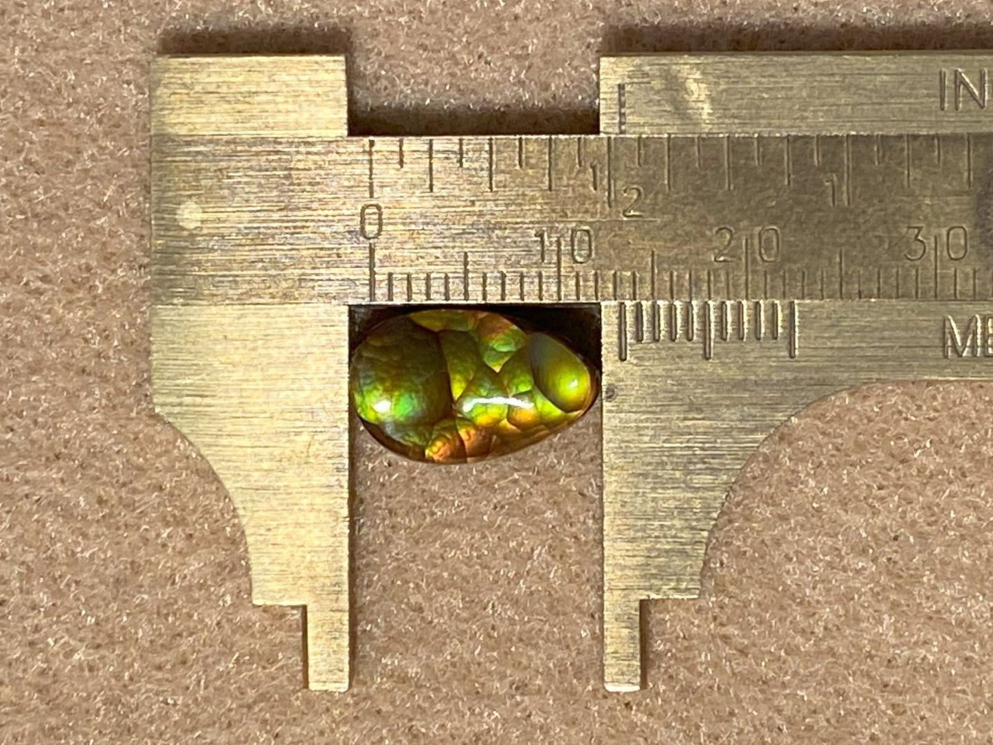An Aguascalientes fire agate gemstone with a ruler showing its size