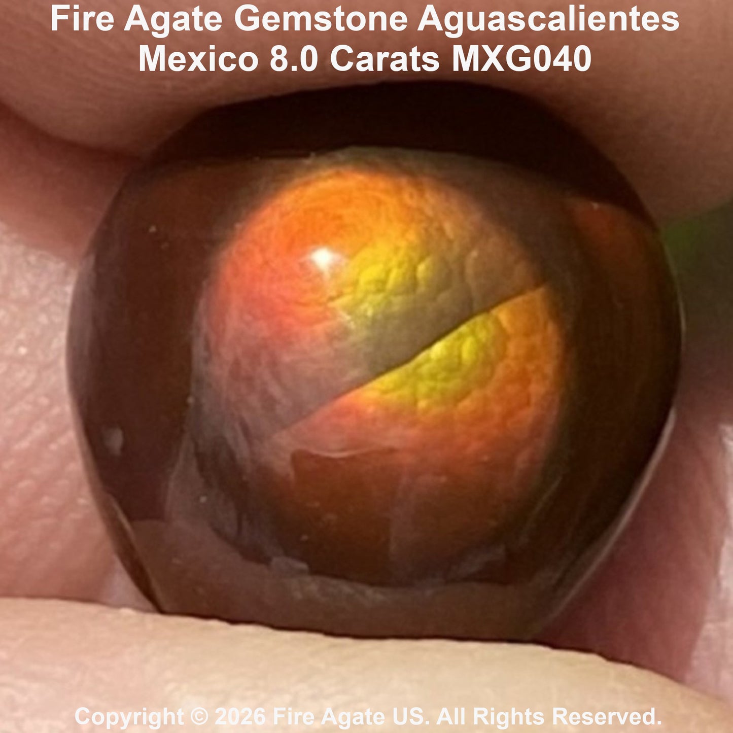 A close-up of a polished fire agate gemstone held in fingers, showing a warm brown base with vivid orange and yellow fiery inclusions. Text at the top reads 'Fire Agate Gemstone Aguascalientes Mexico'.