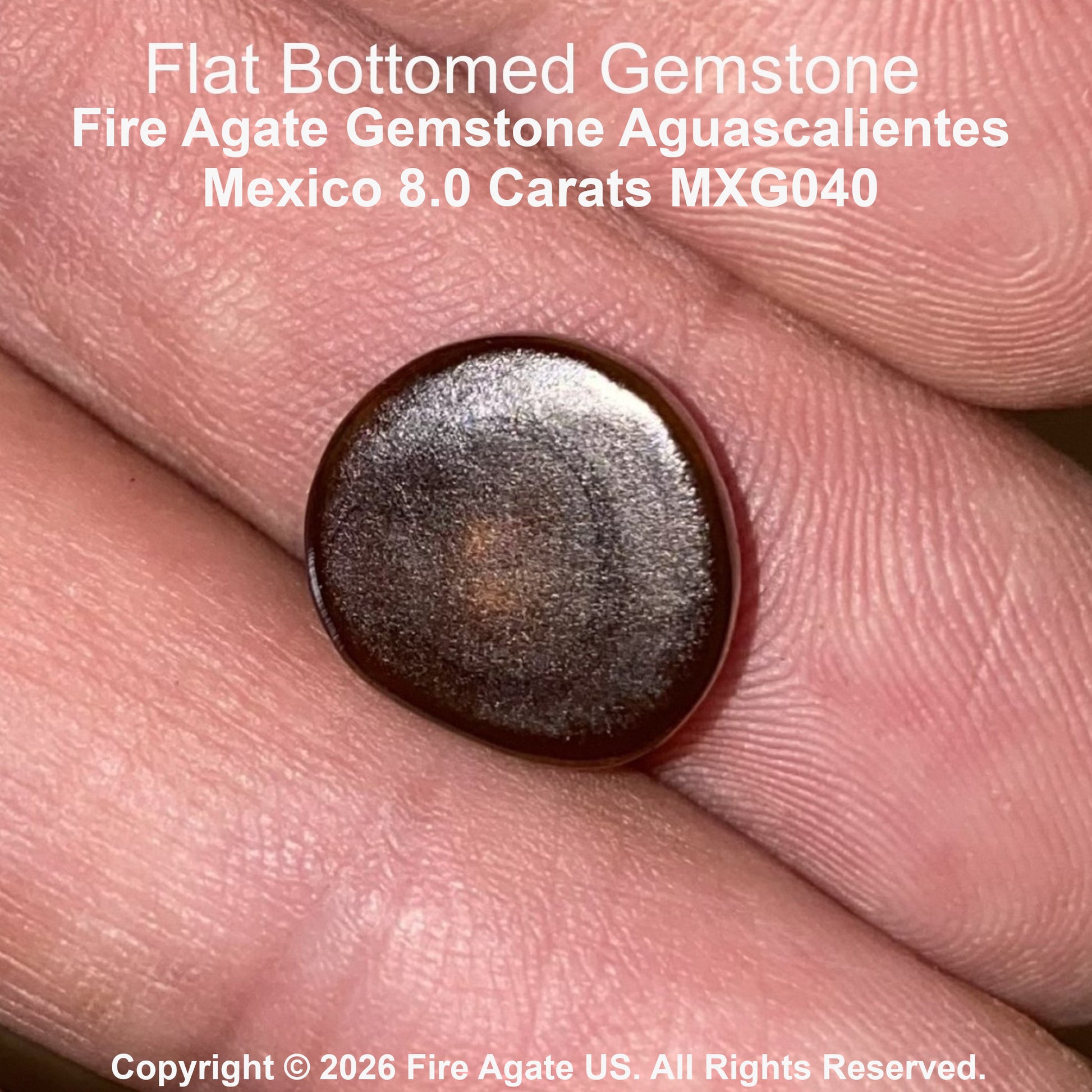 A close up of a flat bottomed fire agate gemstone resting on a person's fingers, with text overlay identifying it as 'Flat Bottomed Gemstone Fire Agate Gemstone Aguascalientes Mexico 8.0 Carats MXG040'.