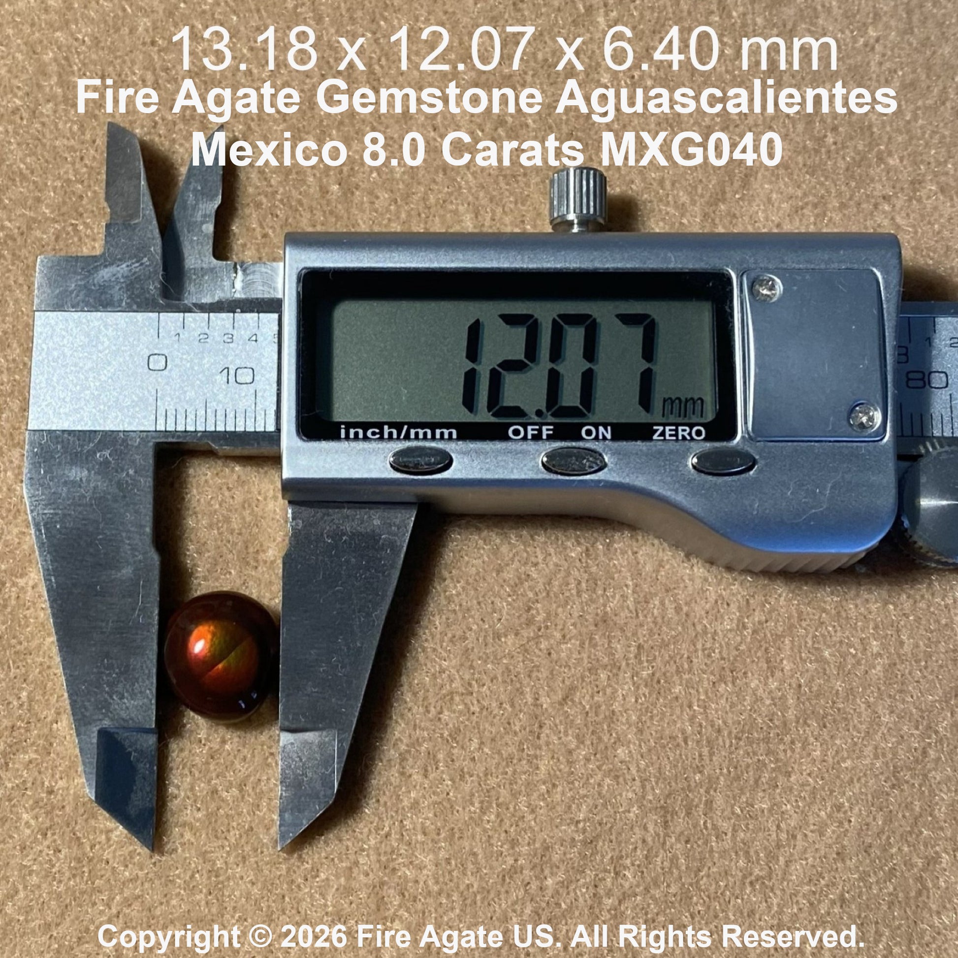 A 8.0 carat fire agate gemstone with a fiery orange brown color, shown next to a digital caliper displaying 12.07 mm.