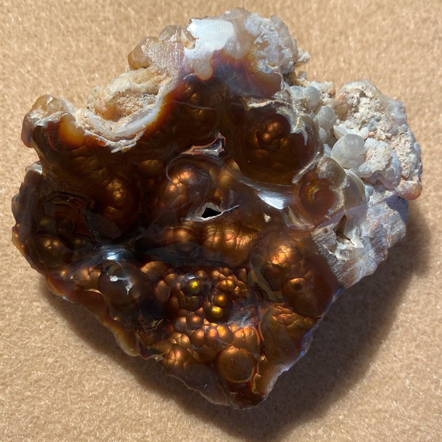 Close-up of a brown crystal Aguascalientes Fire Agate Rough on a beige background