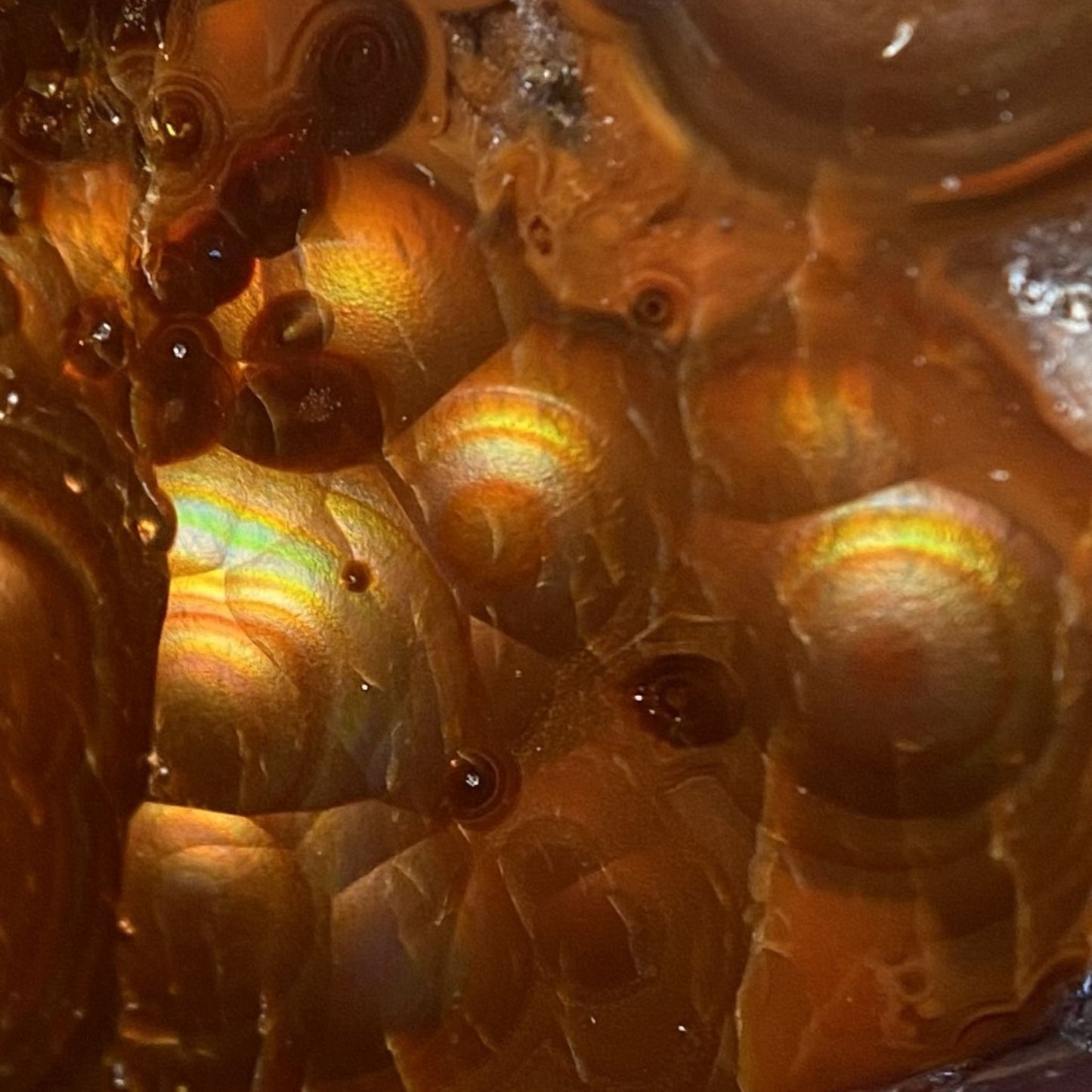 Close-up of a textured fire agate surface with orange and brown colors