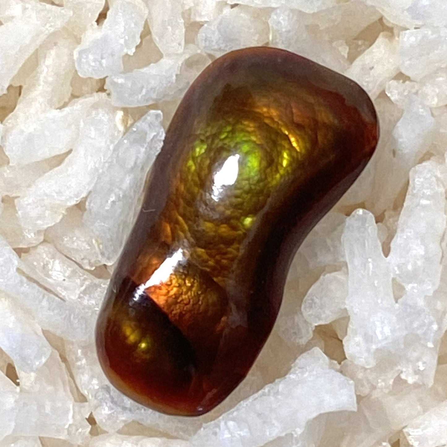Multicolored Slaughter Mountain Fire Agate Gemstone on a bed of white rice
