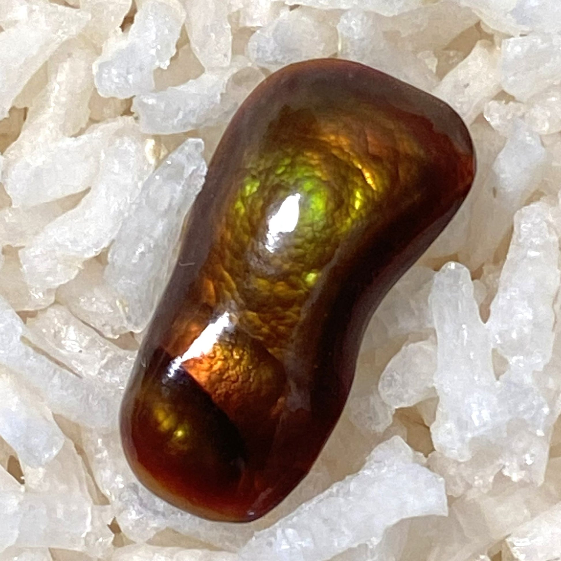 Multicolored Slaughter Mountain Fire Agate Gemstone on a bed of white rice