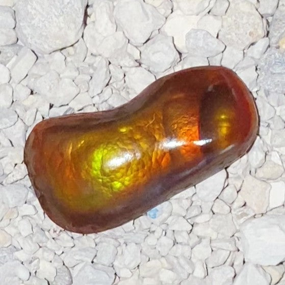 Slaughter Mountain Fire Agate Gemstone on a bed of small stones