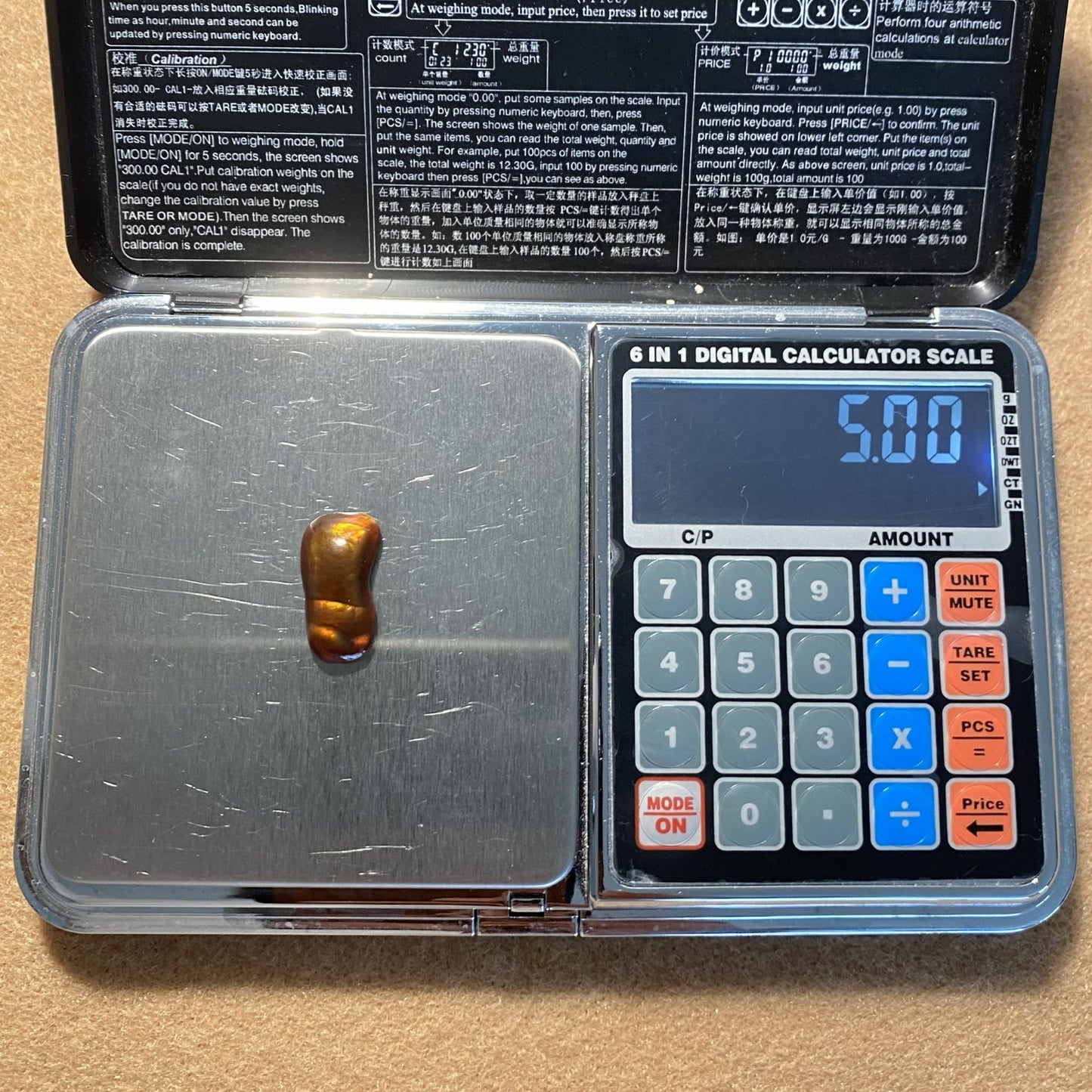 Digital calculator scale with a gemstone on the weighing platform