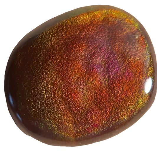 Multicolored fiery Slaughter Mountain fire agate gemstone with a metallic sheen on a white background