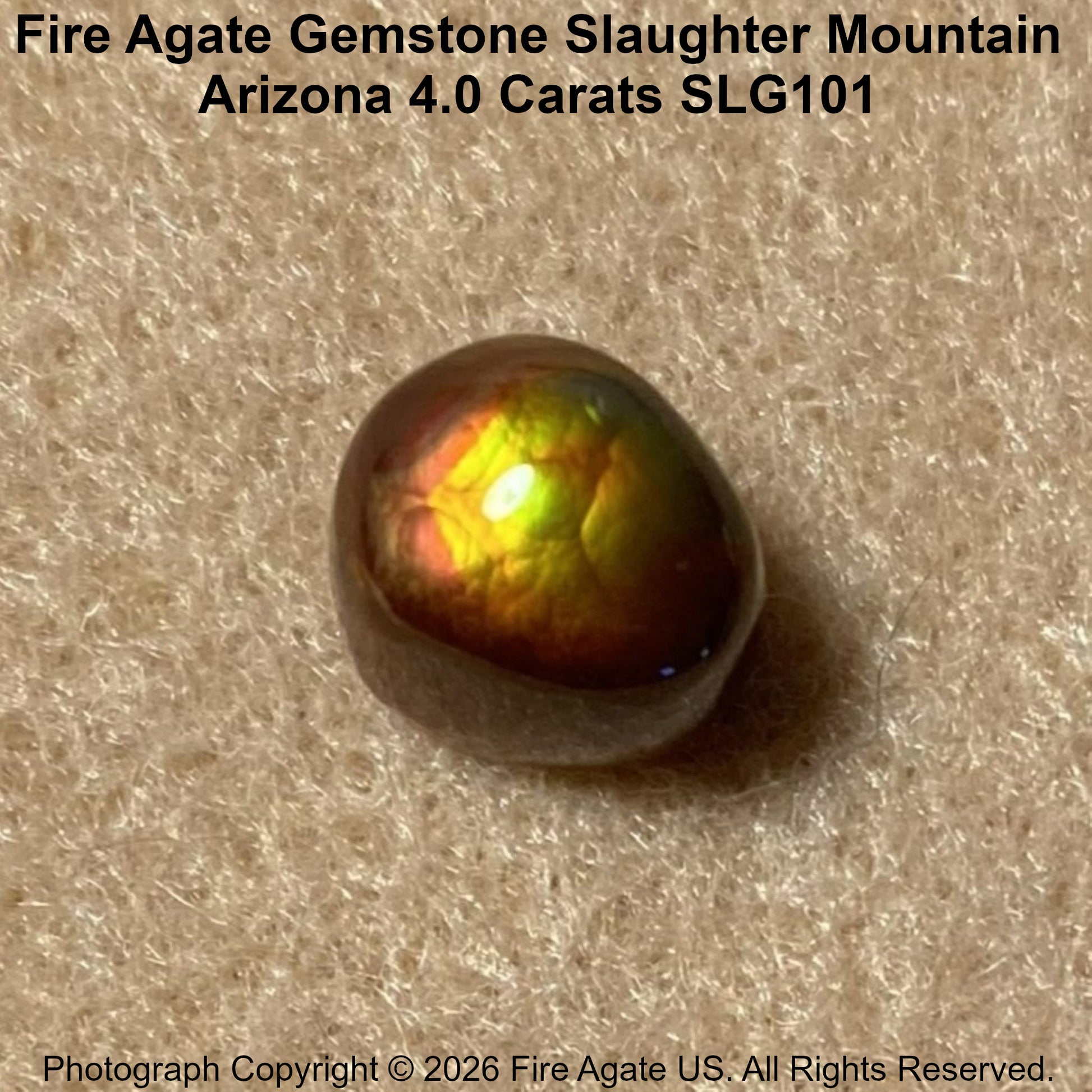 A 4.0 carat fire agate gemstone with a polished, glossy finish, displaying vibrant iridescent flashes of yellow, green, orange, and red on a textured beige background.