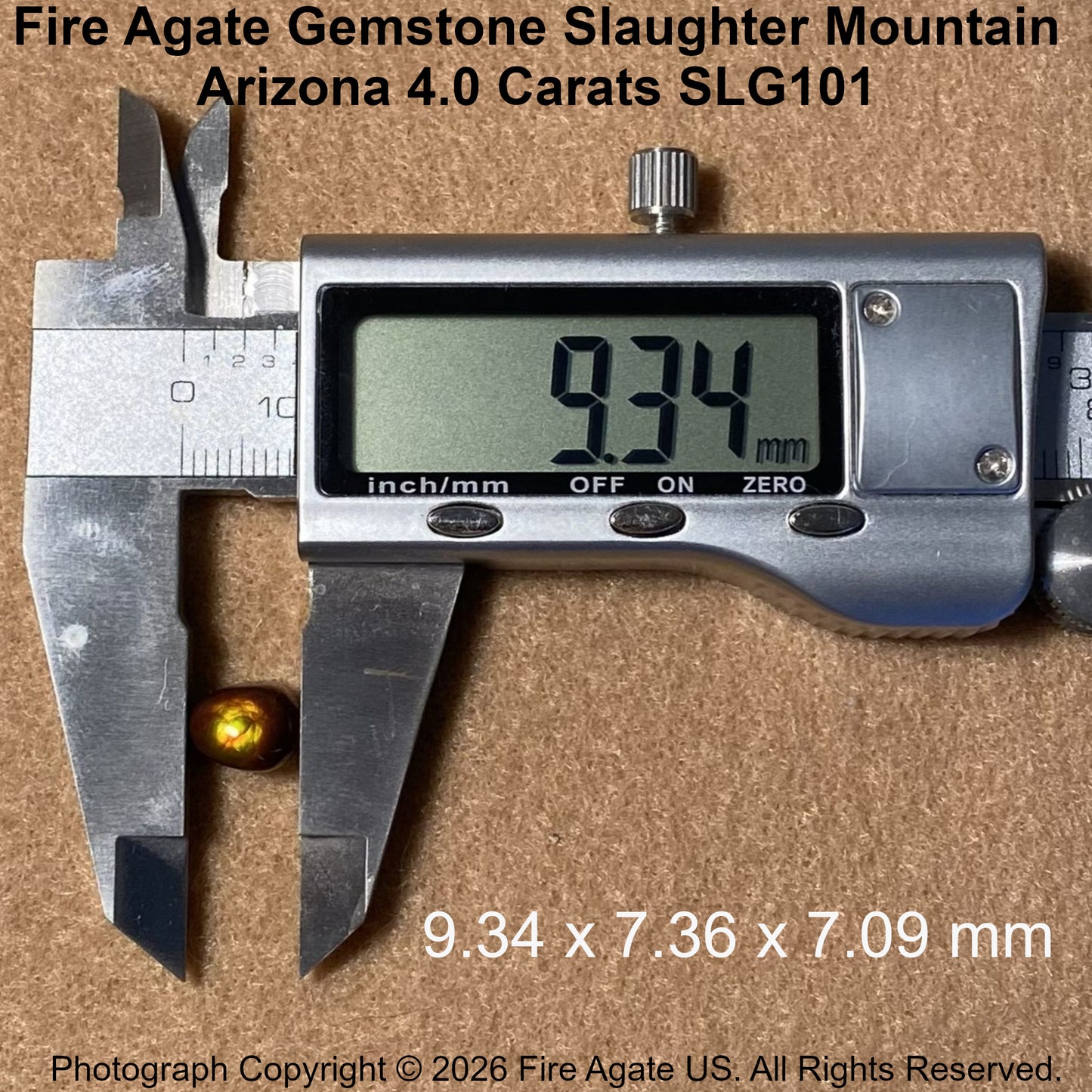 A 4.0 carat fire agate gemstone in a small gold-toned bezel setting, shown next to a digital caliper displaying 9.34 mm.