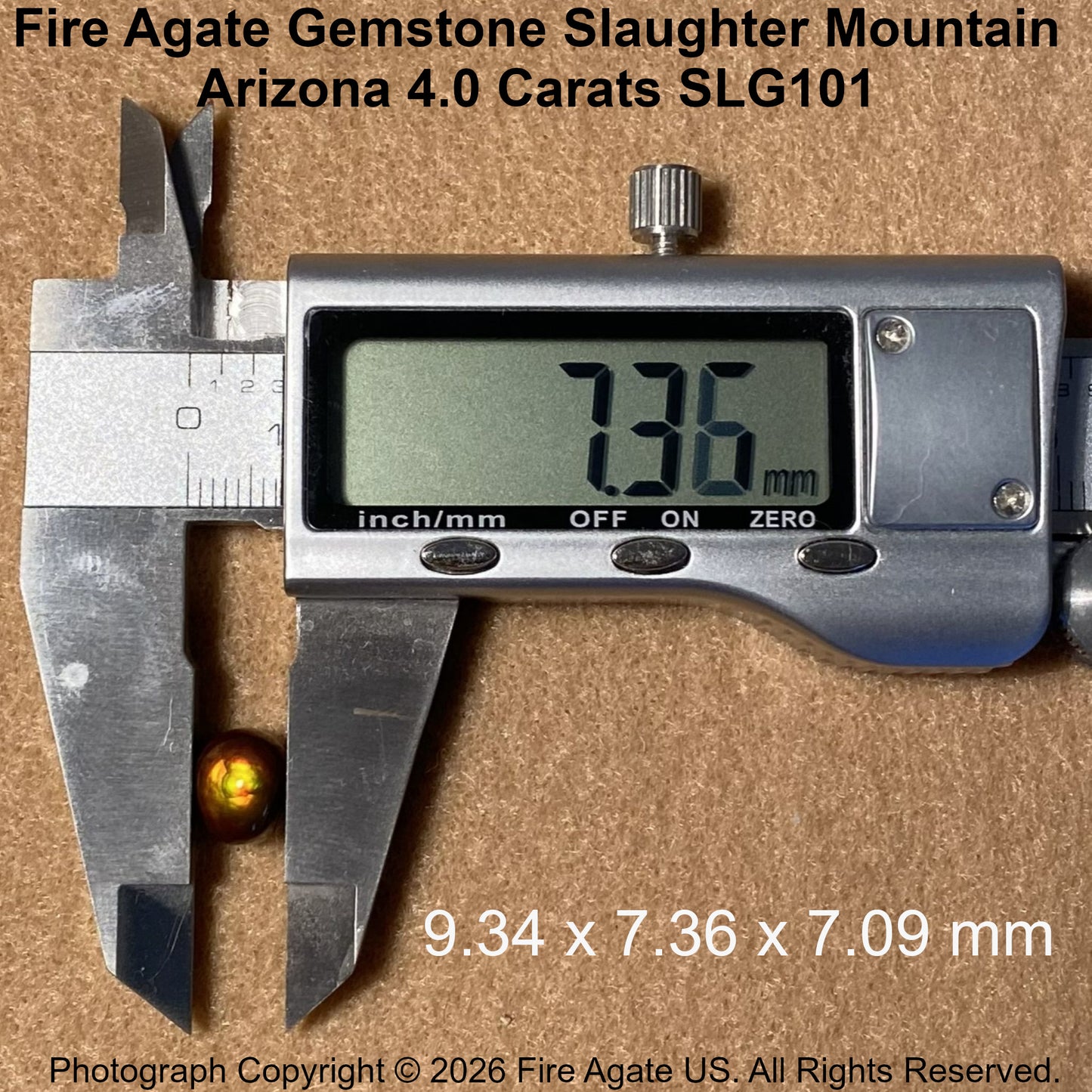 A 4.0 carat Fire Agate gemstone with a golden-yellow hue and dark center, shown next to a digital caliper measuring 7.36 mm.