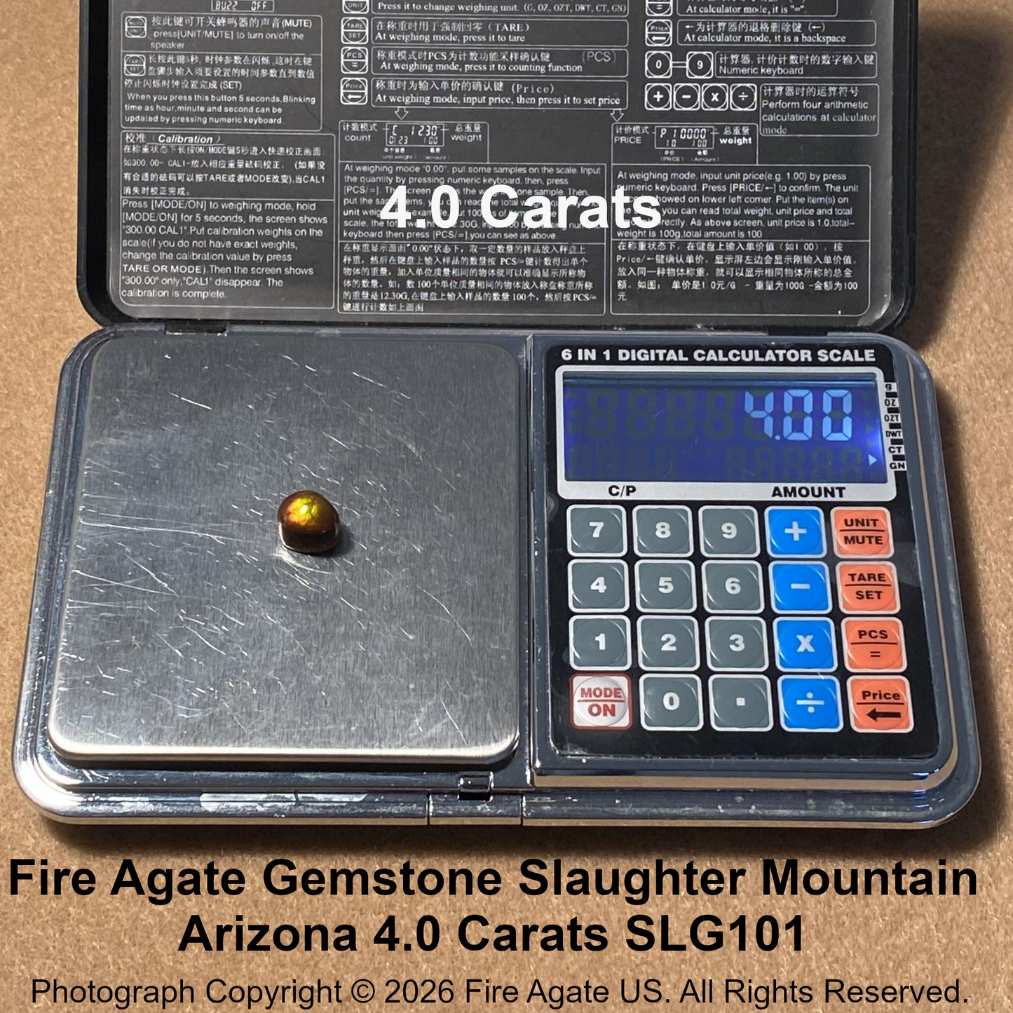 A digital scale with a small fire agate gemstone placed on its weighing platform, shown open with a printed instruction panel inside. Large text overlays reads 4.0 carats.
