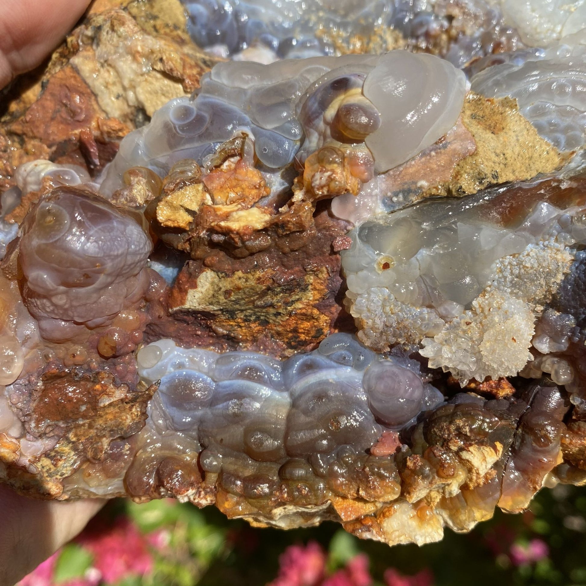 Close-up of a Slaughter Mountain Arizona Fire Agate Rough Mineral Specimen crystal formation with various colors on a rock background
