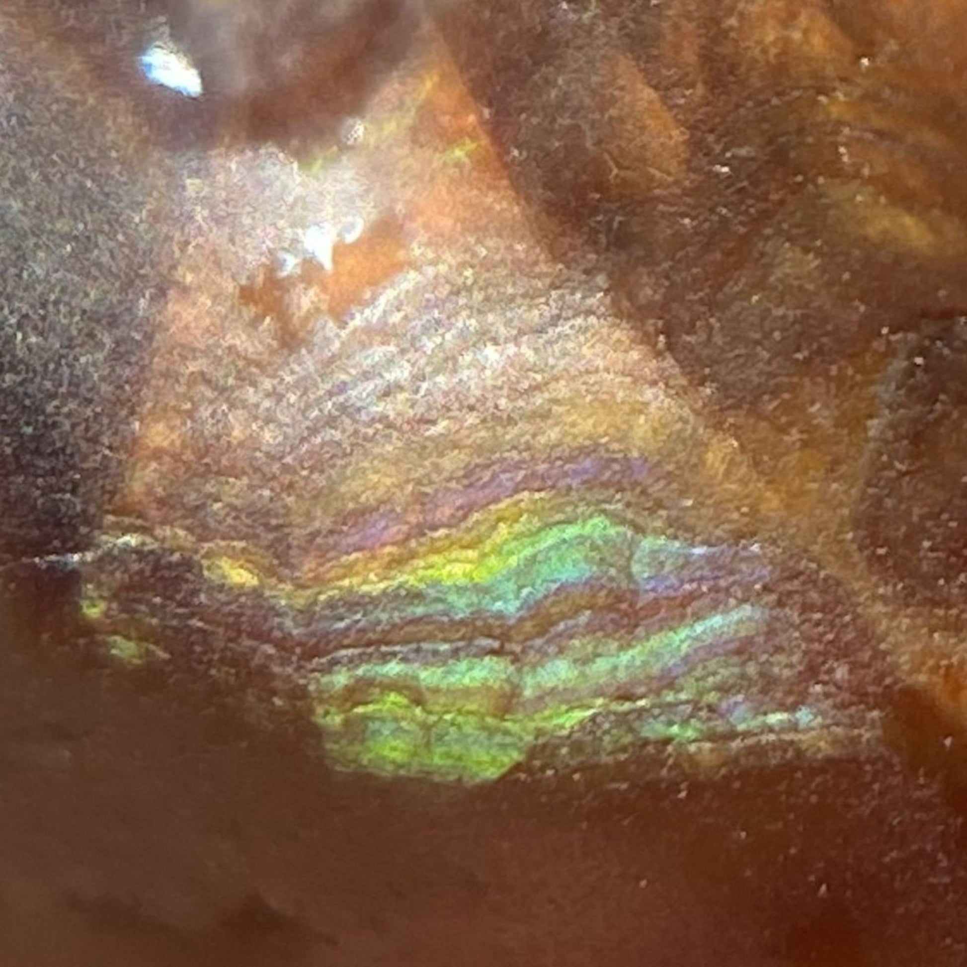 Close-up of a textured surface with reflective, multicolored pattern