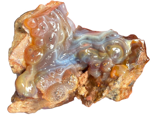 Close-up of a piece of Slaughter Mountain fire agate rough with visible  fire banding patterns.