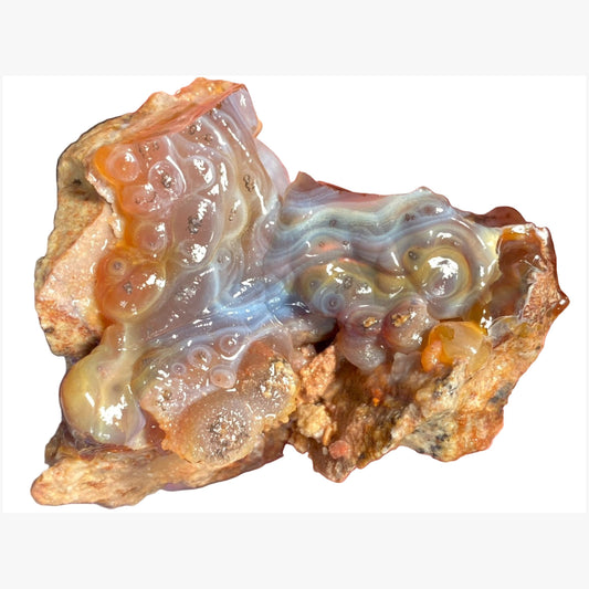 High Grade Slaughter Mountain Fire Agate Rough with a translucent, bubble like interior on a white background