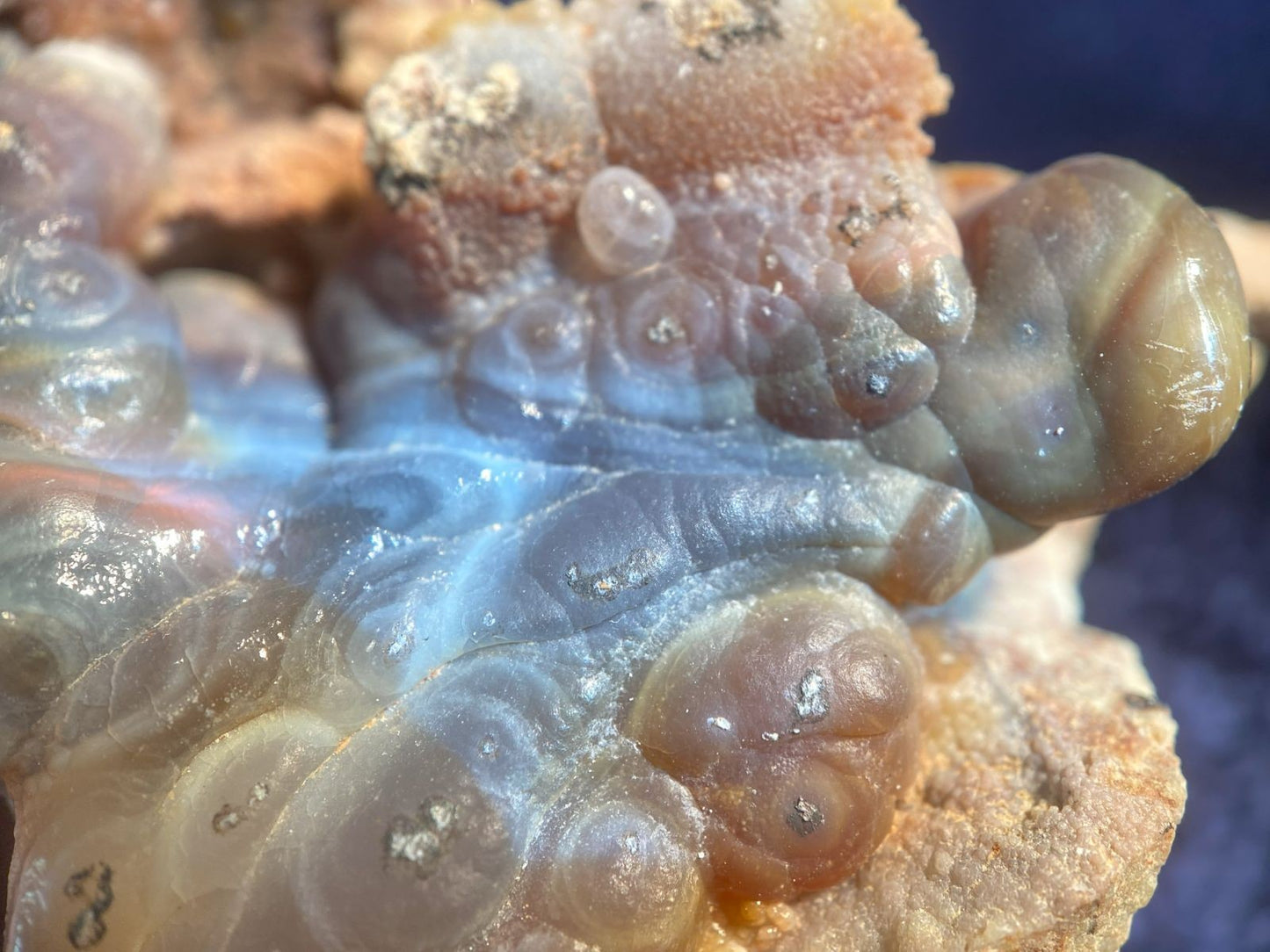 Close-up of a textured surface of High Grade Slaughter Mountain Fire Agate Rough with brown and gray colors