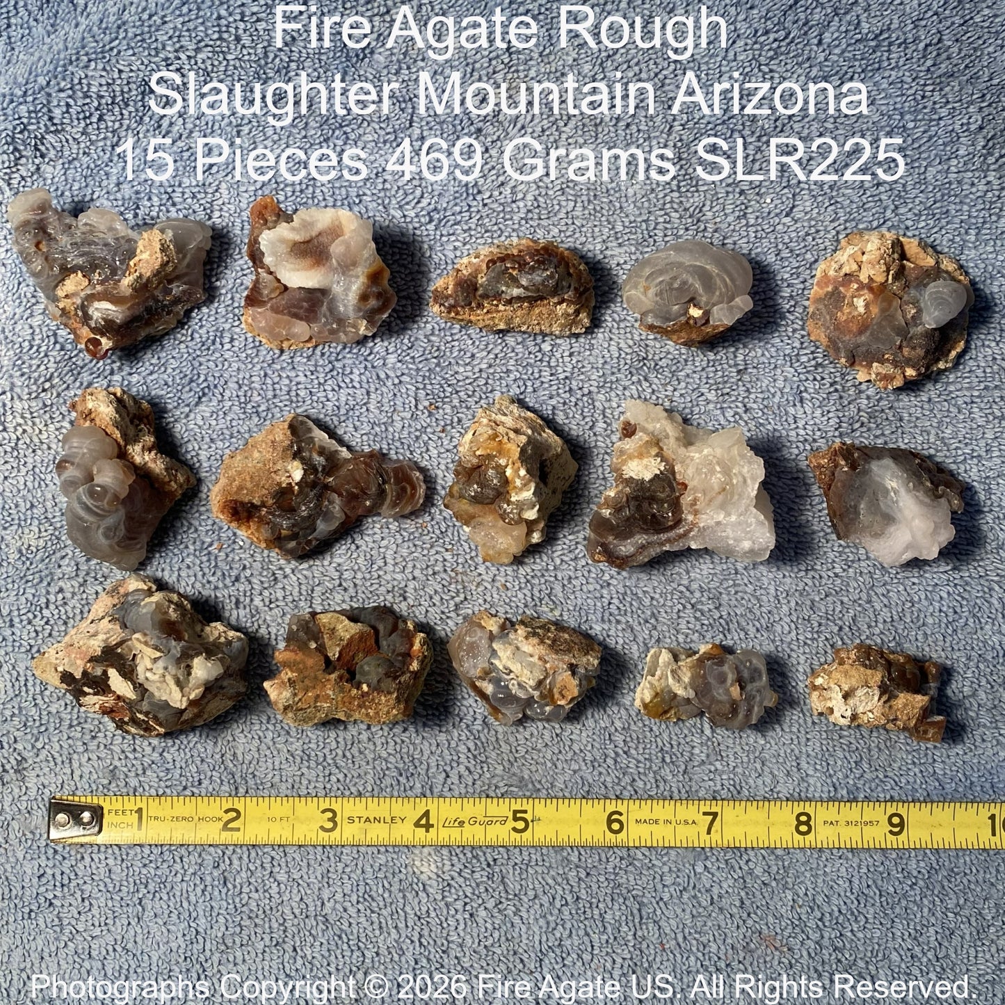 Collection of Fire Agate Rough from Slaughter Mountain, Arizona with a measuring tape for scale.