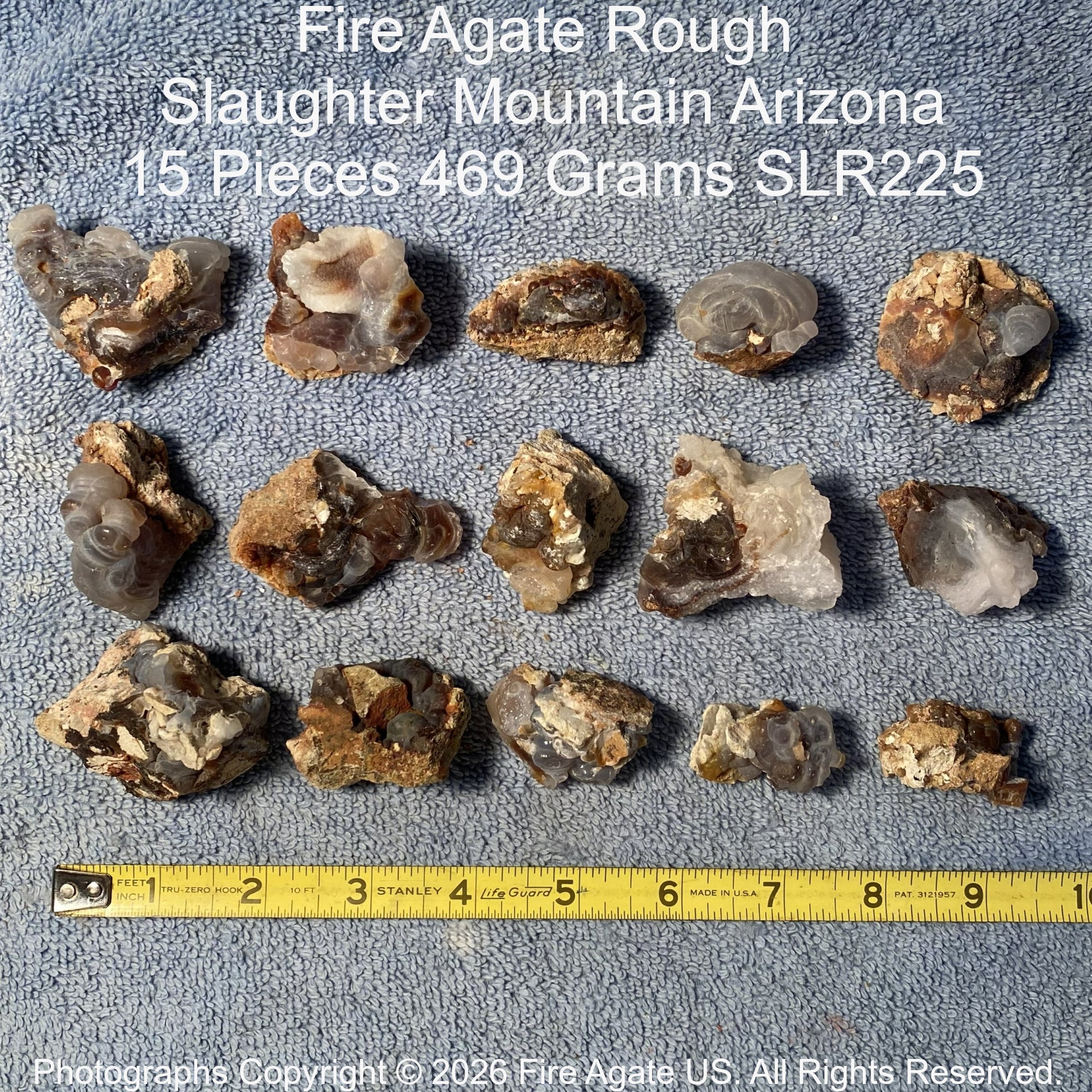 Collection of Fire Agate Rough from Slaughter Mountain, Arizona with a measuring tape for scale.