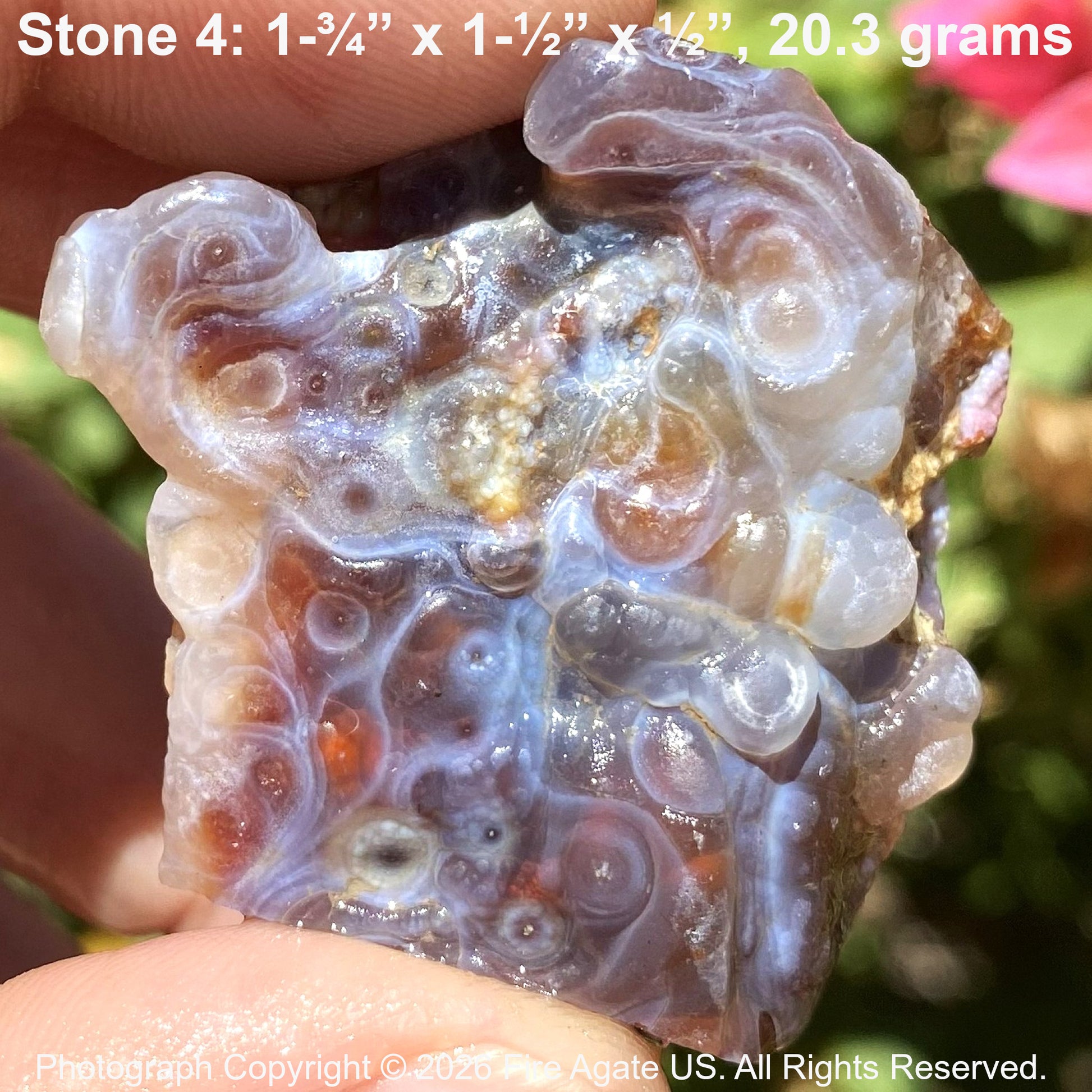 Close-up of a translucent fire agate stone held in hand with text overlay